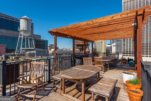 deck with a view of city and a pergola