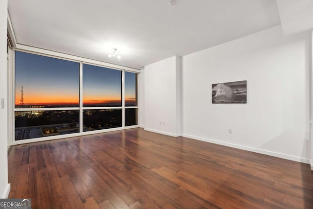 3325 Piedmont Rd NE Unit 1504, Atlanta, GA 30305 - spare room with wood-type flooring, expansive windows, and baseboards