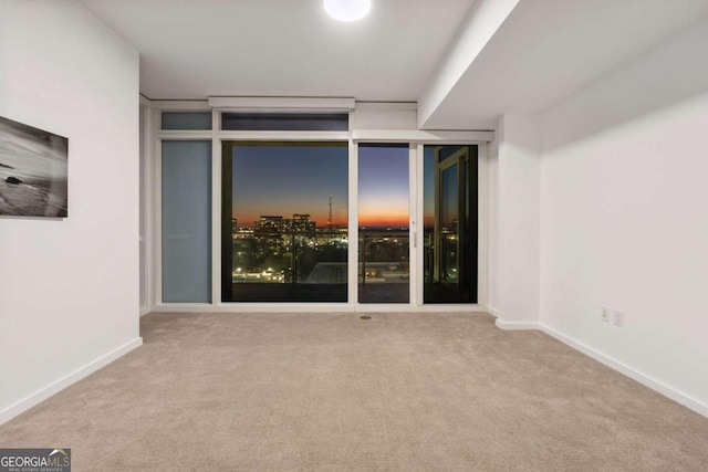 3325 Piedmont Rd NE Unit 1504, Atlanta, GA 30305 - empty room featuring carpet floors, expansive windows, and baseboards