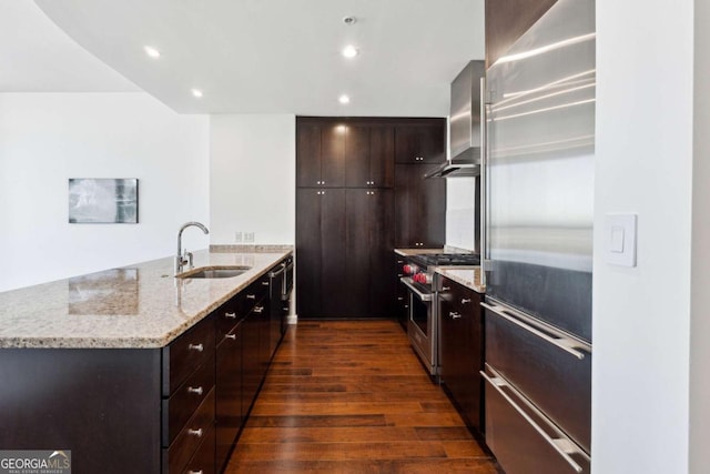 3325 Piedmont Rd NE Unit 1504, Atlanta, GA 30305 - kitchen featuring premium appliances, a peninsula, a sink, wall chimney range hood, and dark wood finished floors