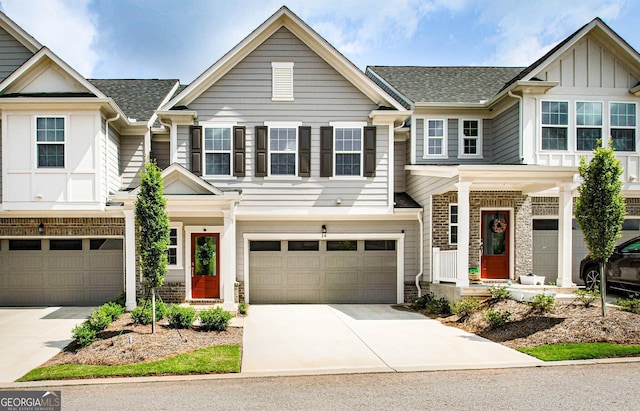 view of property featuring board and batten siding, concrete driveway, and an attached garage