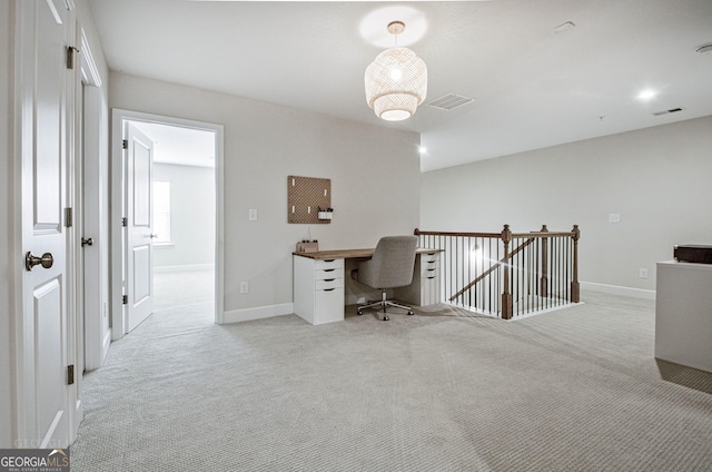 home office featuring light colored carpet, visible vents, and baseboards