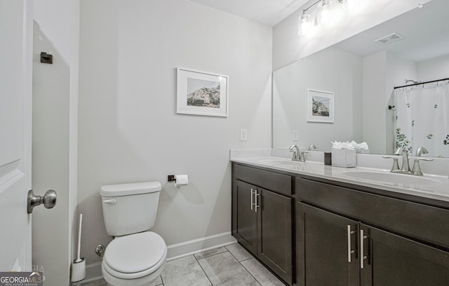 full bath featuring toilet, double vanity, visible vents, and a sink