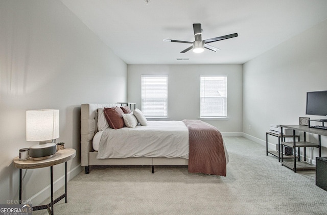 bedroom with baseboards, visible vents, ceiling fan, and light colored carpet