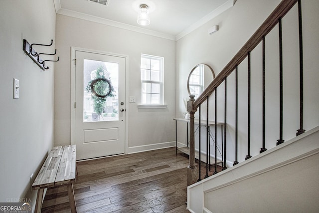 foyer with stairway, baseboards, ornamental molding, and wood finished floors