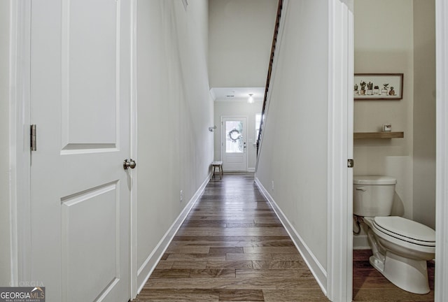 hall with dark wood finished floors and baseboards