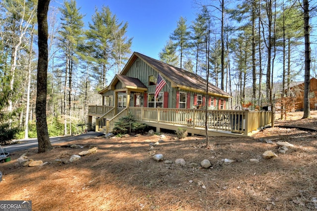 rustic home featuring board and batten siding and a wooden deck