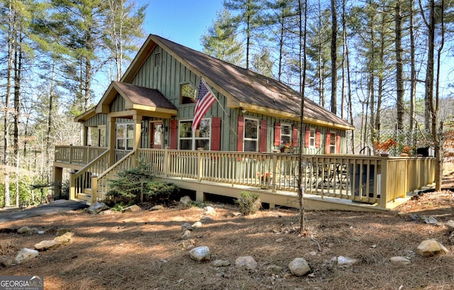 rustic home featuring a deck and board and batten siding