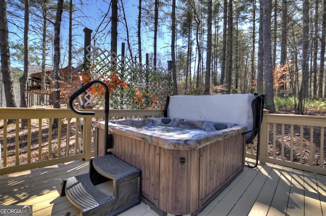 wooden terrace featuring a hot tub