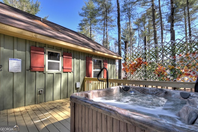 wooden terrace featuring a hot tub