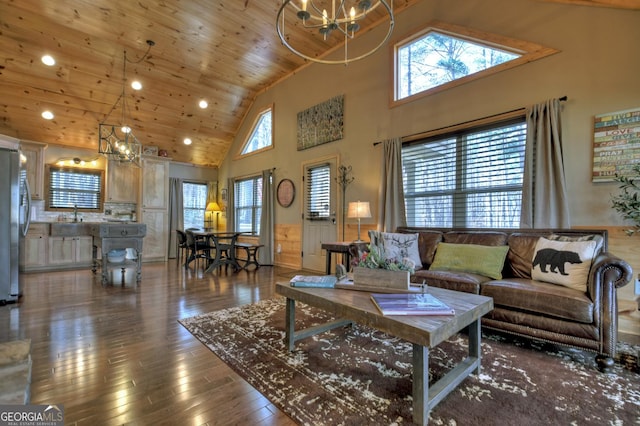 living area featuring a wealth of natural light, wooden ceiling, hardwood / wood-style flooring, and an inviting chandelier