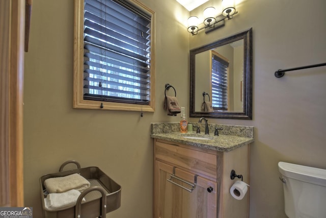 bathroom featuring toilet and vanity