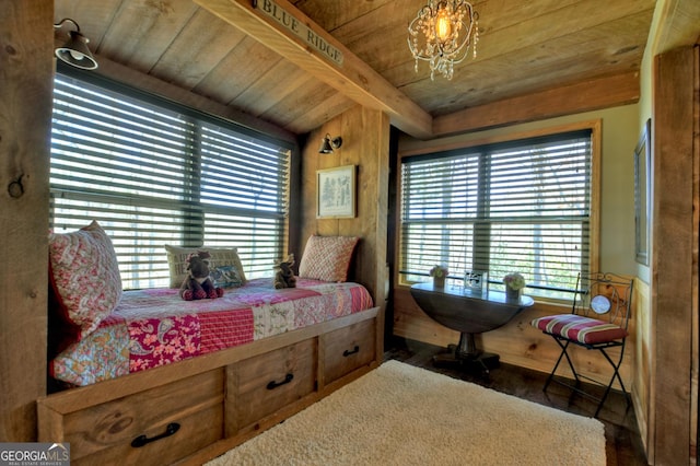 bedroom featuring a chandelier, beamed ceiling, and wooden ceiling