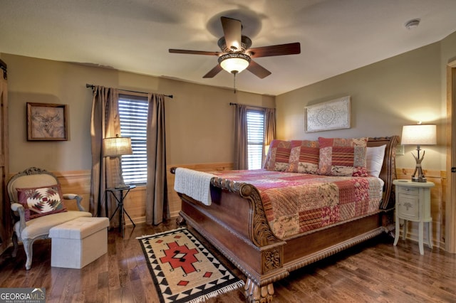 bedroom with multiple windows, wood finished floors, and a ceiling fan