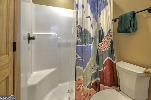 full bathroom with a stall shower and toilet