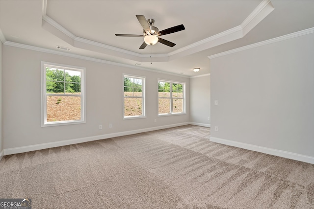 spare room with visible vents, baseboards, a ceiling fan, a tray ceiling, and carpet floors