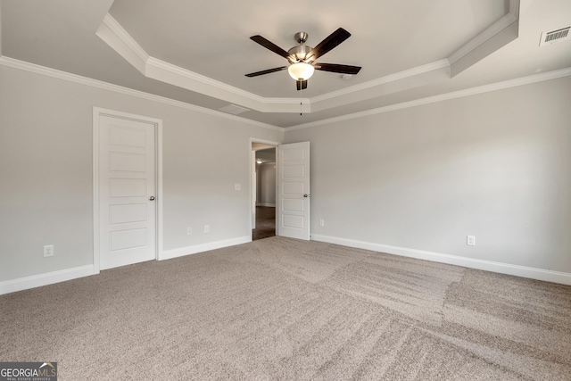 unfurnished bedroom with carpet floors, baseboards, visible vents, and a raised ceiling