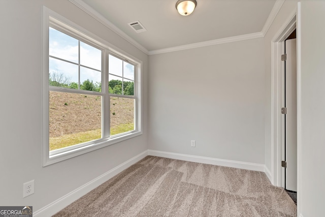 unfurnished room with carpet, visible vents, ornamental molding, and baseboards