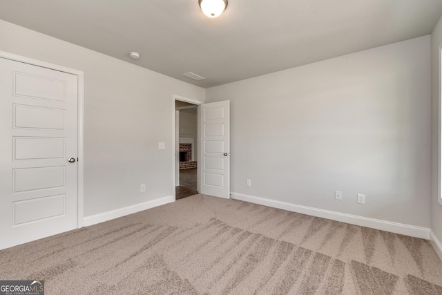 unfurnished bedroom featuring carpet, visible vents, and baseboards