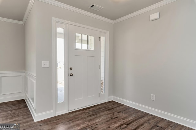 entrance foyer with crown molding, visible vents, dark wood-type flooring, and wainscoting