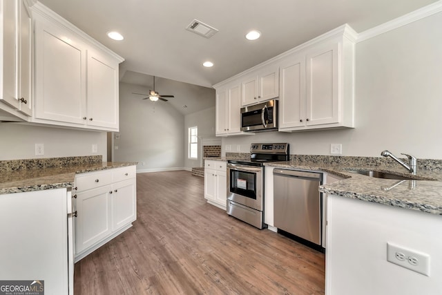 kitchen featuring stainless steel appliances, visible vents, a sink, and white cabinetry