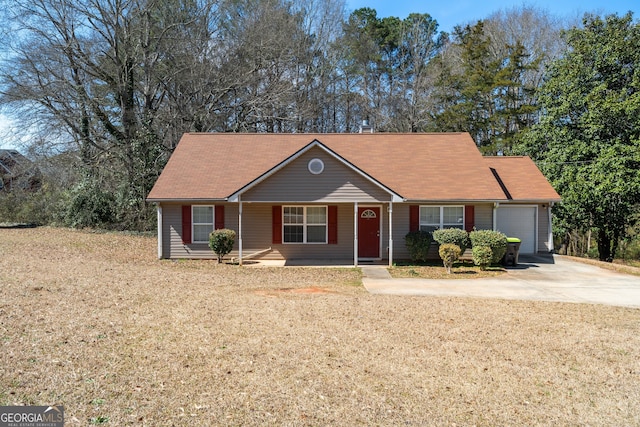 single story home with a front lawn, concrete driveway, and a garage