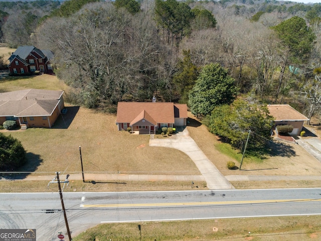 drone / aerial view with a wooded view