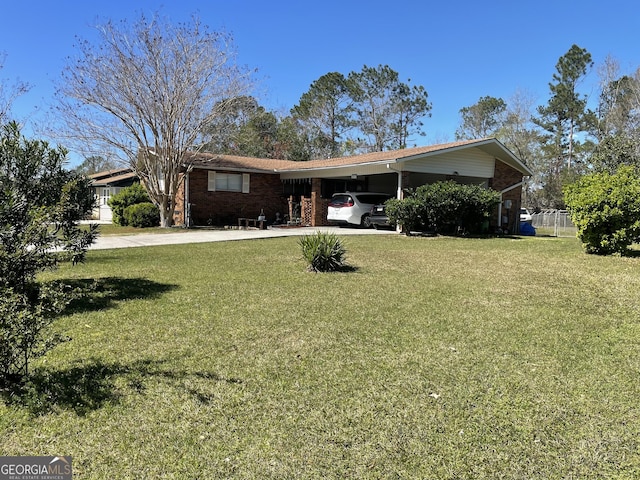 ranch-style home featuring an attached carport, brick siding, driveway, and a front yard