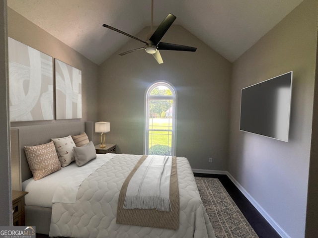 bedroom with ceiling fan, baseboards, vaulted ceiling, and wood finished floors