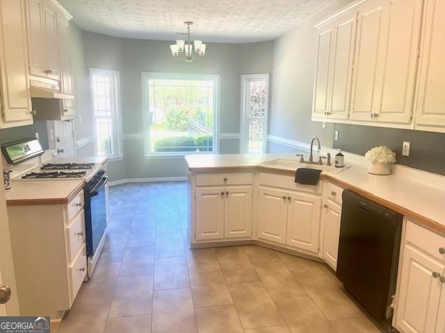 kitchen featuring black dishwasher, light countertops, white cabinets, and range with gas stovetop