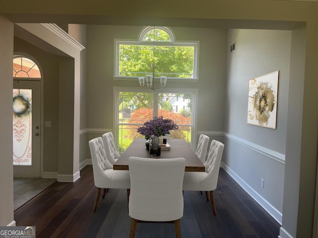 dining space with baseboards, visible vents, a chandelier, and dark wood-style flooring