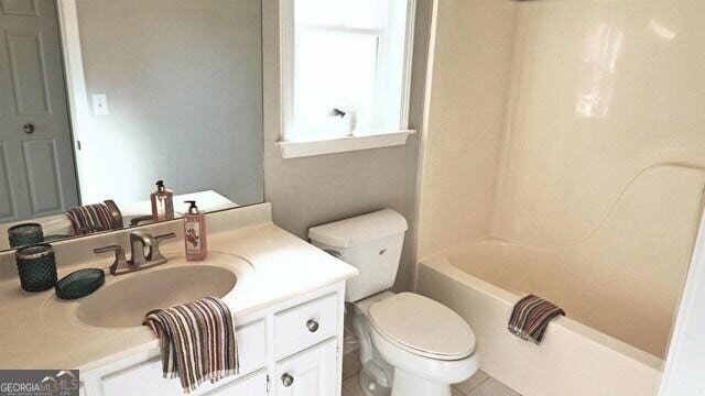 full bath with shower / tub combination, vanity, and toilet