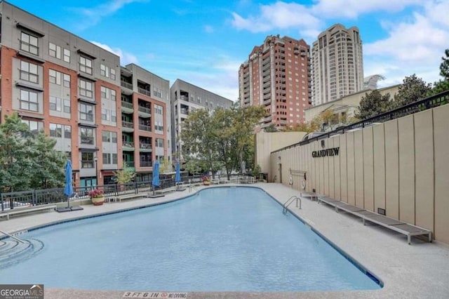 view of pool featuring fence