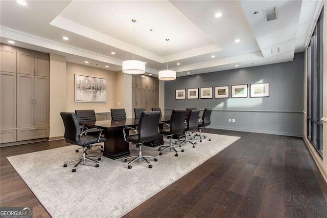 office area with a raised ceiling, visible vents, and dark wood finished floors