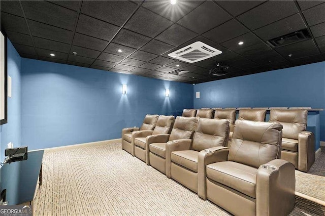 carpeted home theater featuring a drop ceiling, visible vents, and baseboards