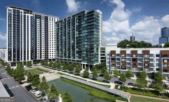 view of property with a water view and a city view