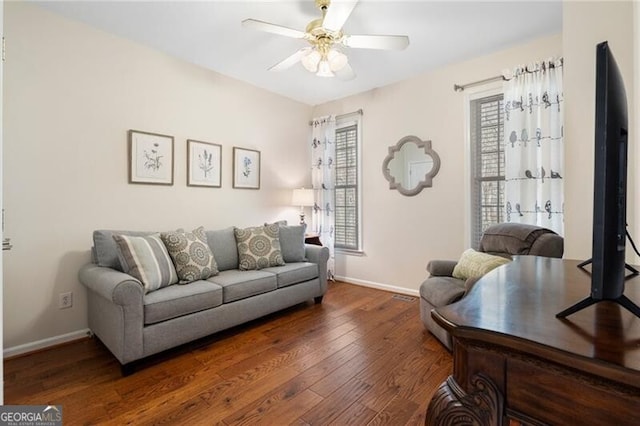 living room with ceiling fan, hardwood / wood-style floors, and baseboards