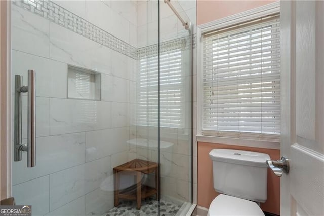 full bath with a stall shower and toilet