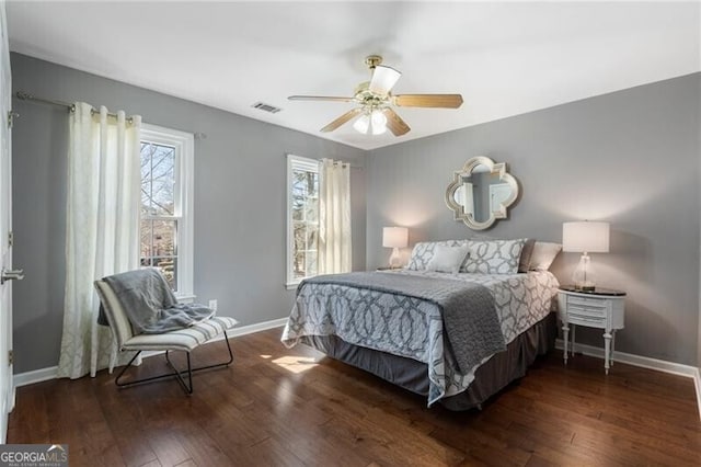 bedroom with visible vents, ceiling fan, baseboards, and hardwood / wood-style flooring