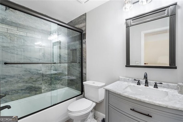 full bath featuring toilet, baseboards, vanity, and enclosed tub / shower combo