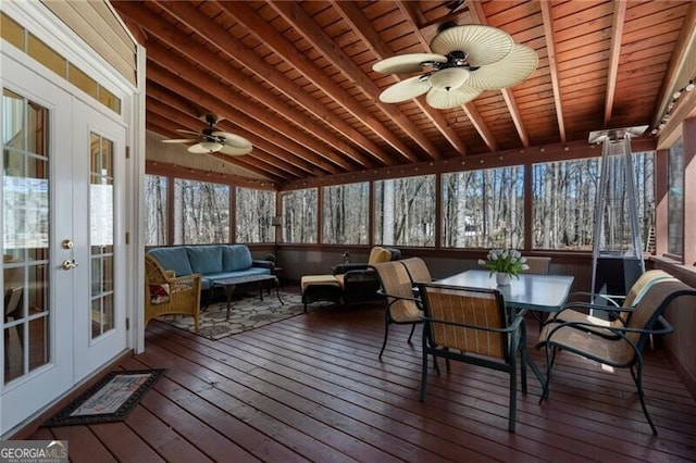 sunroom / solarium featuring vaulted ceiling with beams, wooden ceiling, and a ceiling fan