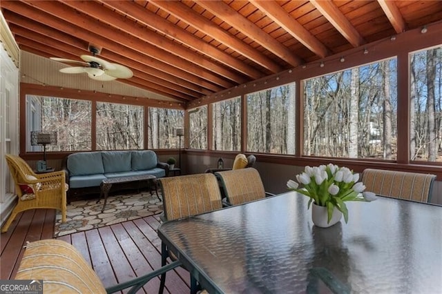 sunroom with a ceiling fan, wood ceiling, and lofted ceiling with beams