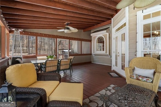 sunroom featuring a ceiling fan, beam ceiling, and wooden ceiling