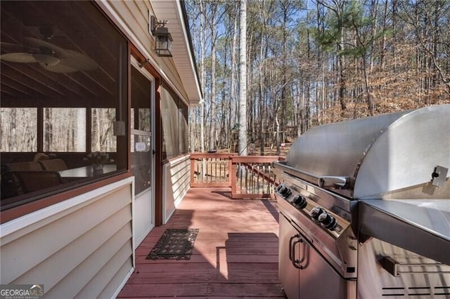 deck with a grill and a ceiling fan