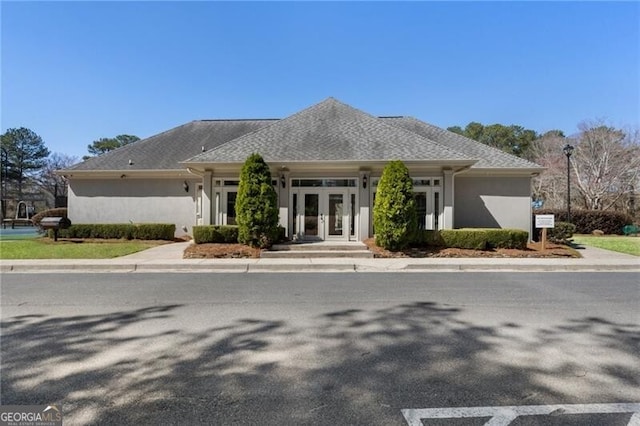 view of front of home featuring stucco siding and french doors