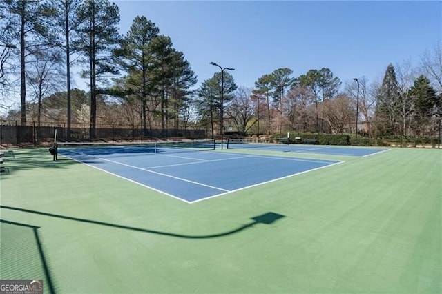 view of sport court featuring community basketball court and fence