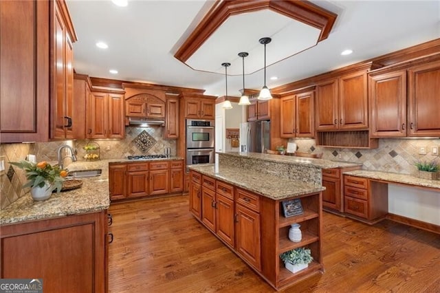 kitchen with brown cabinets, stainless steel appliances, open shelves, and a sink