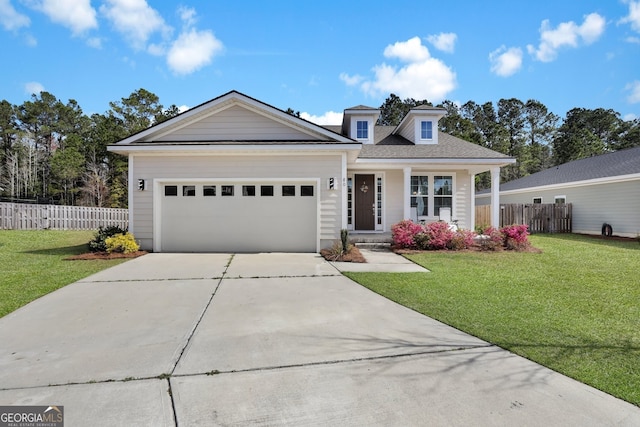 view of front of home with a garage, fence, a front lawn, and concrete driveway