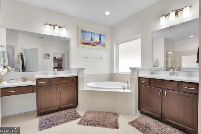 bathroom featuring two vanities, a sink, a bath, and a shower stall