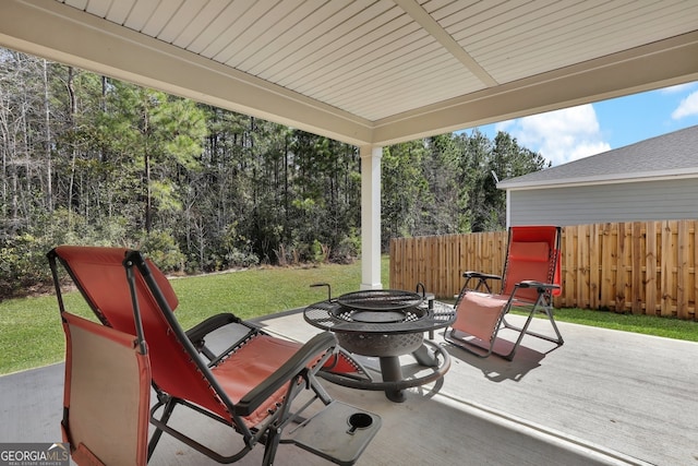 view of patio with an outdoor fire pit and fence